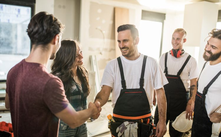 Daily Home Rebuild craftsmen discussing a renovation plan with homeowners