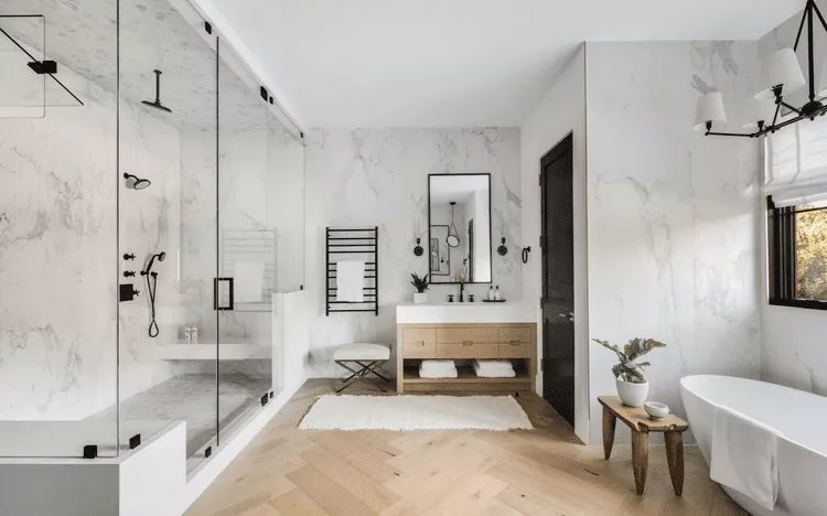 Minimal remodeled bathroom with freestanding tub and natural light