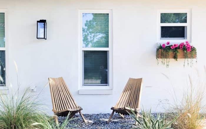 Renovated home exterior with landscaped garden and stone pathway