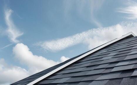 New architectural shingle roof on a residential home against a blue sky
